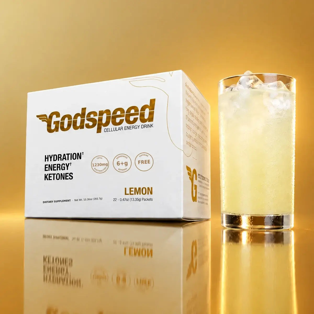 Godspeed Cellular Energy Drink Lemon box beside a glass of the lemon drink on gold